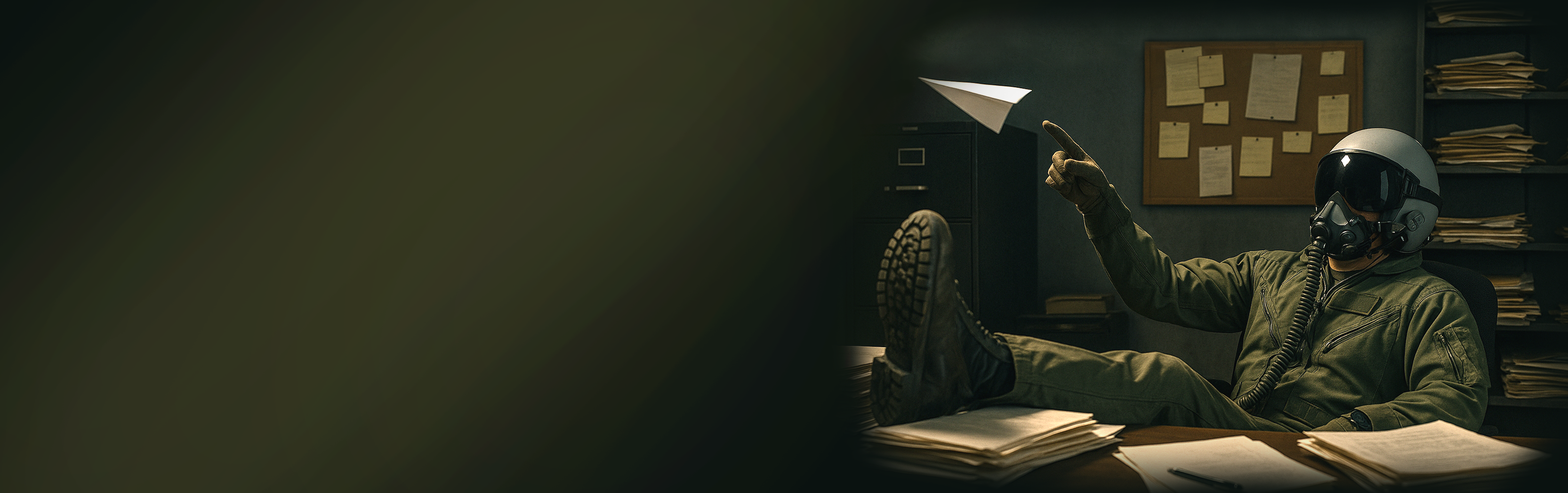 Person in military uniform reading a document in a dimly lit room with posters on the wall.