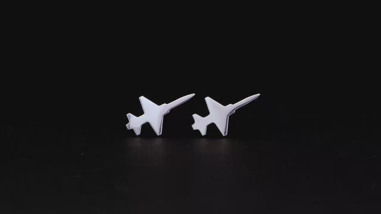 Load video: Pair of F-5 Military fighter Jet Airplane stud earrings shown on a turntable with a dark background