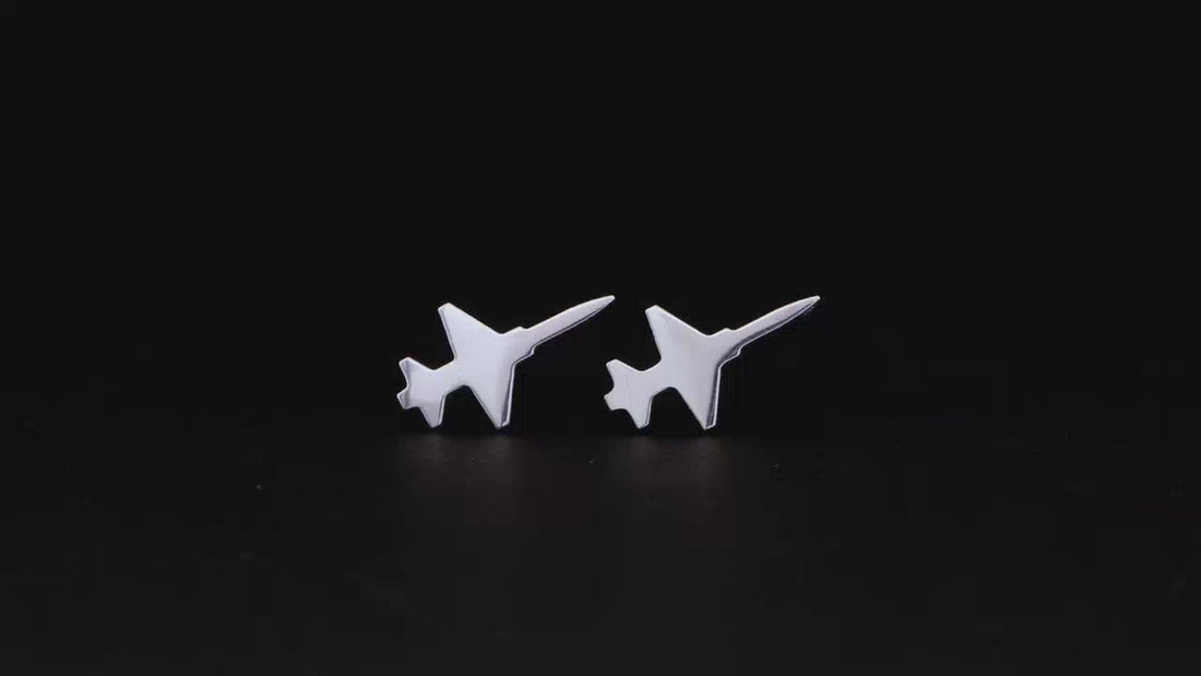 Silver T-38 Talon Military Jet Stud Earrings spinning a black turntable