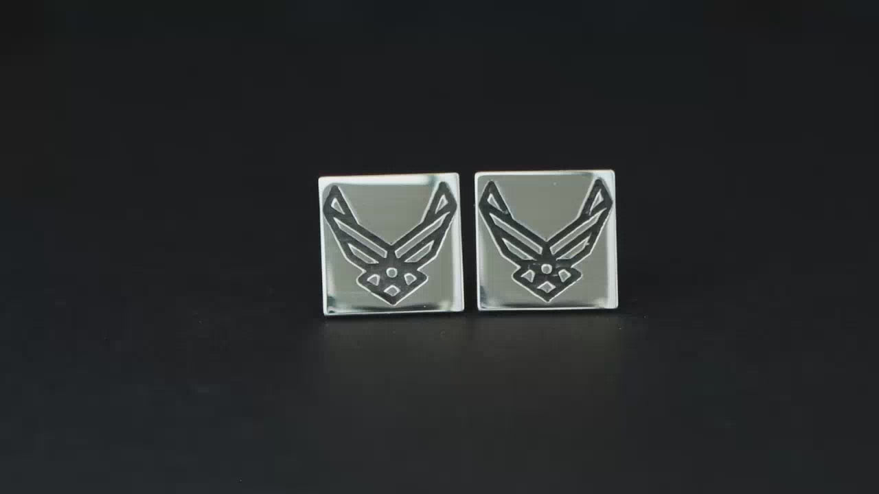 Load video: Pair of Air Force USAF Logo sterling silver stud earrings on a turntable with black background