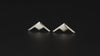 Pair of B-21 Raider Bomber Jet Fighter sterling silver stud earrings on a turntable with a dark background