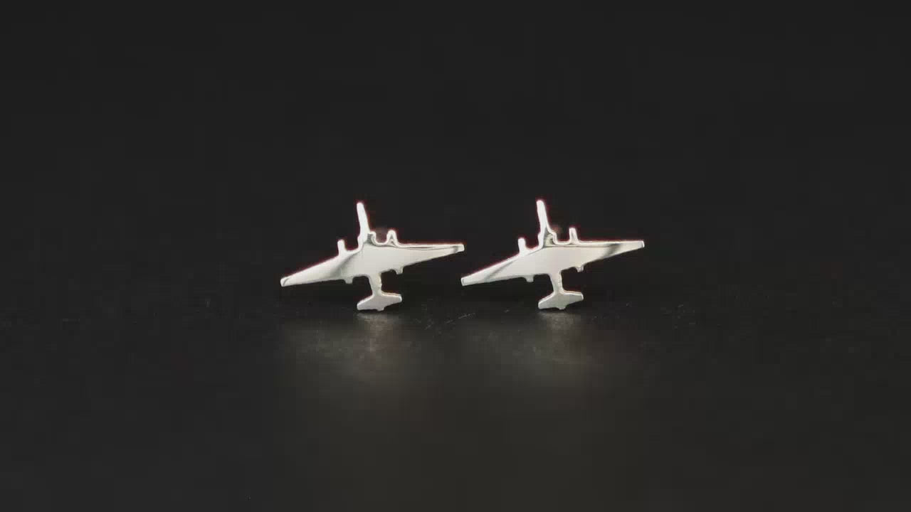 Pair of sterling silver U-2 Dragonlady Jet Fighter Stud earrings on a turntable with a dark background