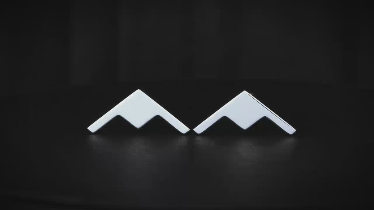 Sterling silver B-21 Raider cuff links in a turntable with a dark background