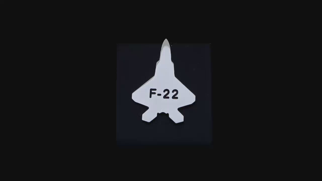 Video of an F-22 tie tack pin on a black backgrouond