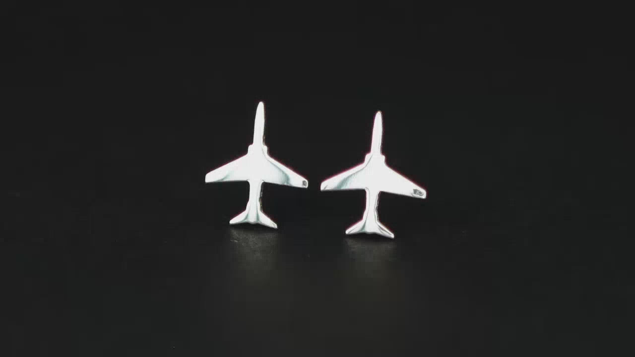 Load video: Pair of sterling silver T-45 Military Jet Fighter Stud earrings on a turntable with a dark background