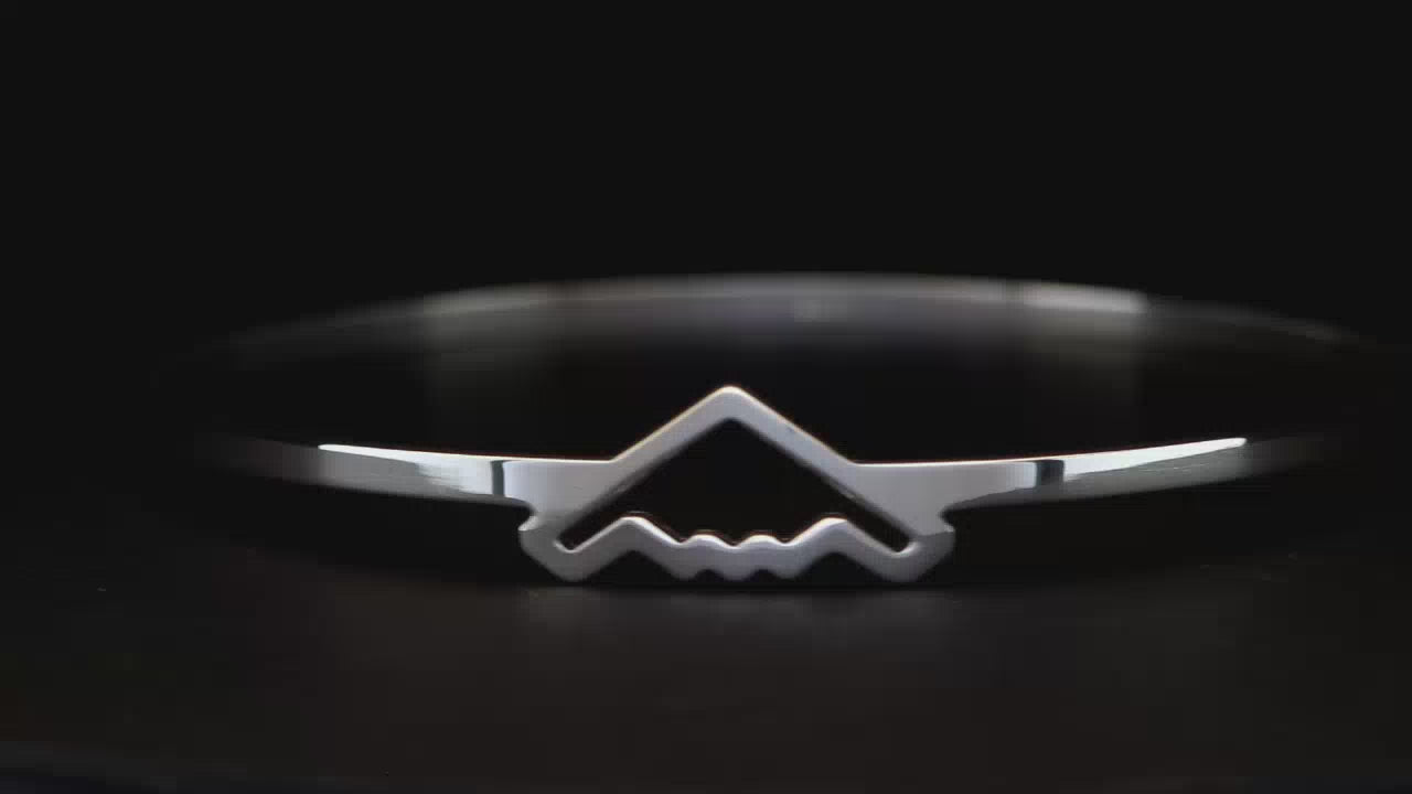 Silver B-2 Bomber Military Jet Bangle Bracelet on a black turntable