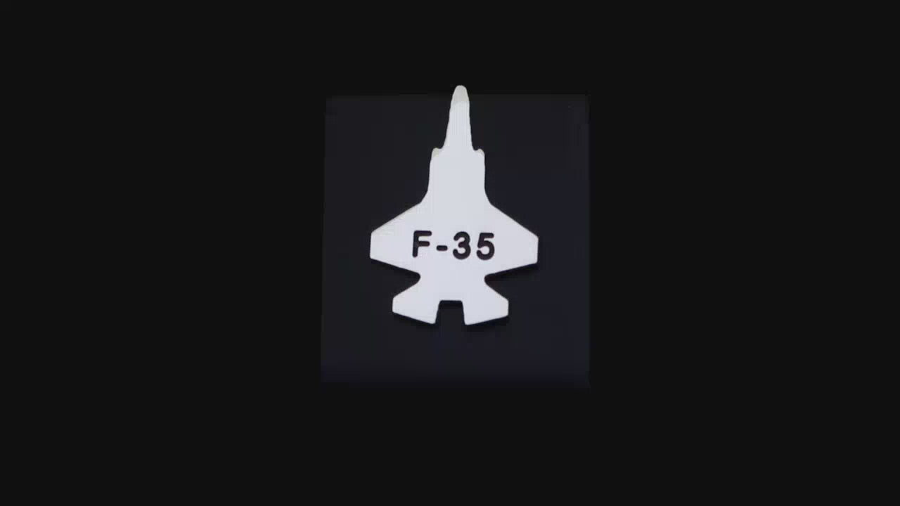 Load video: Sterling silver C-130 Hercules Tie Pin on a turntable with a dark background