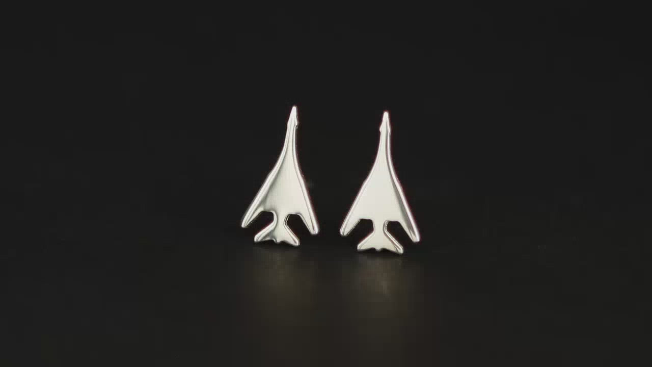 Load video: Pair of B-1 Lancer Jet Fighter Bomber Sterling Silver Stud Earrings on a turntable with a dark background