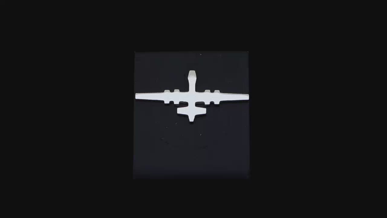 Load video: Sterling silver C-130 Hercules Tie Pin on a turntable with a dark background