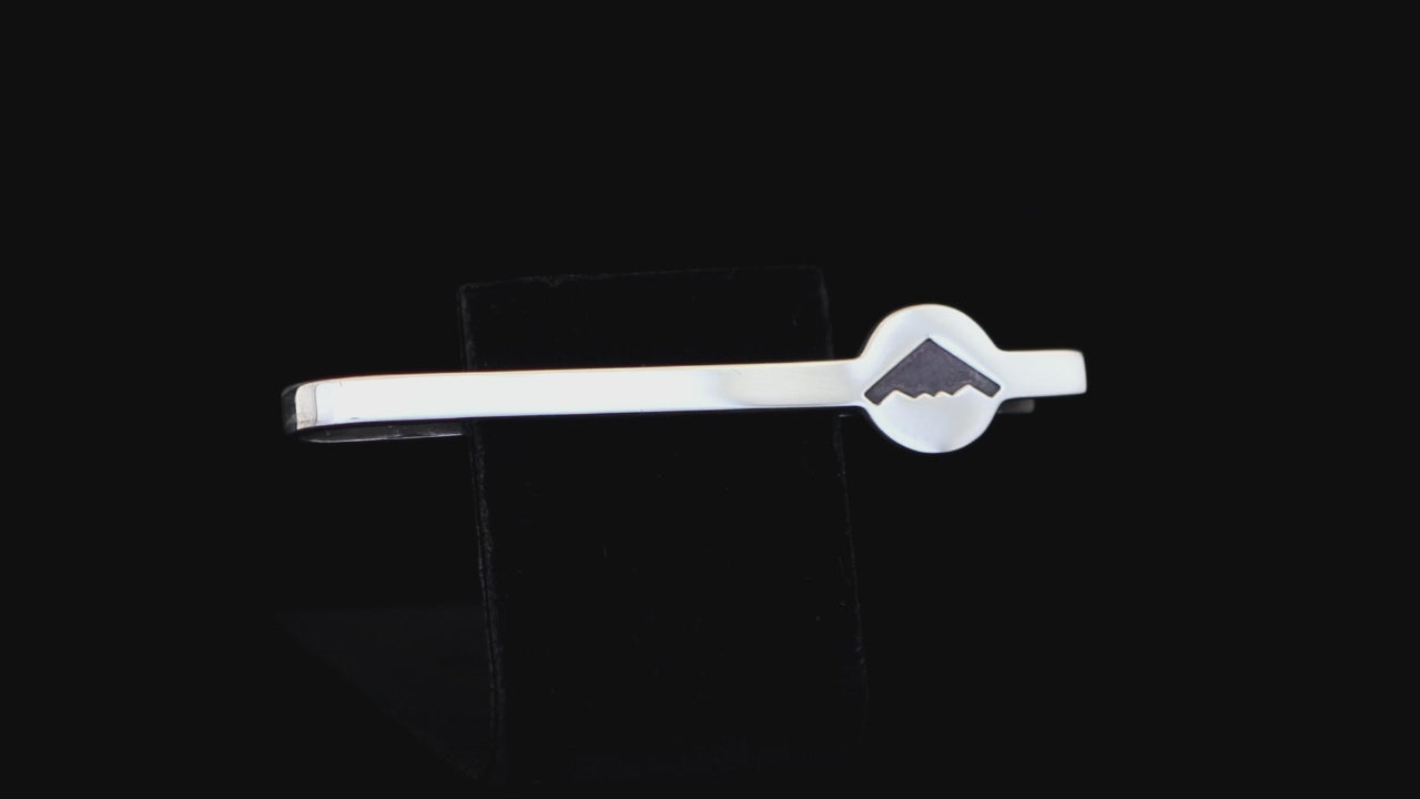 sterling silver B-2 Spirit tie bar with B-2 silhouette on a black background
