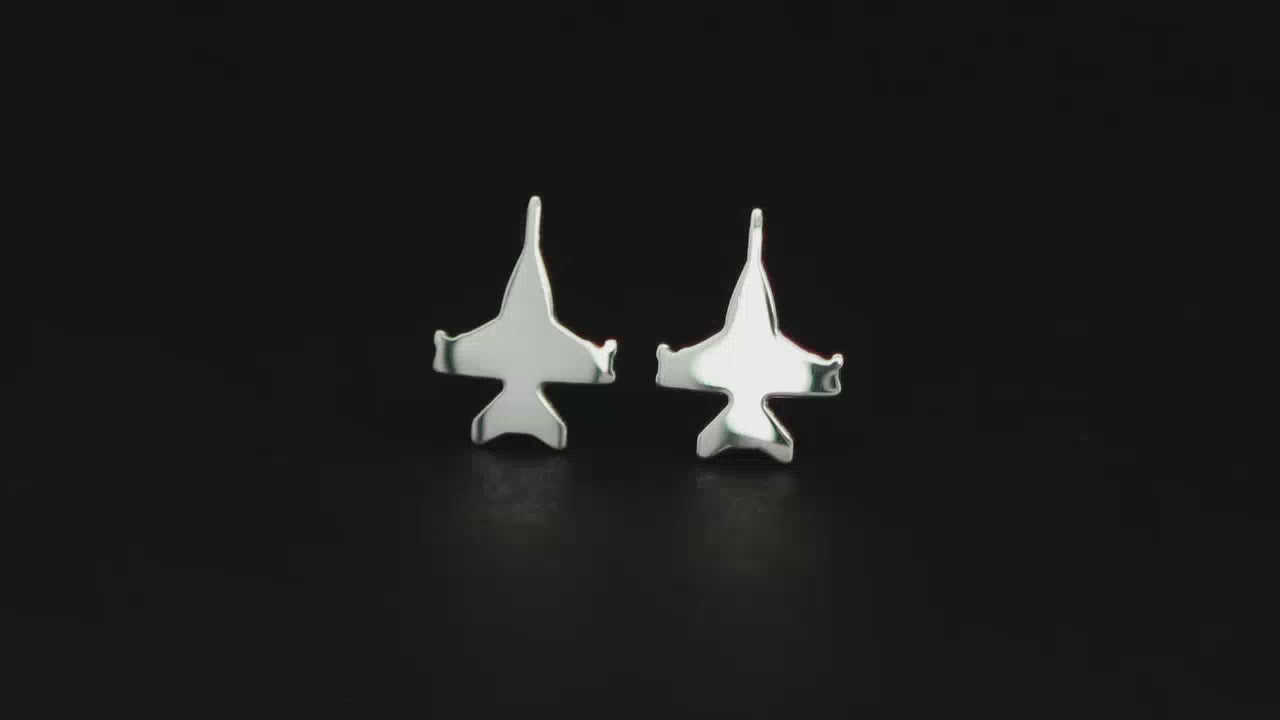 Pair of sterling silver F-18 Jet Fighter Stud earrings on a turntable with a dark background