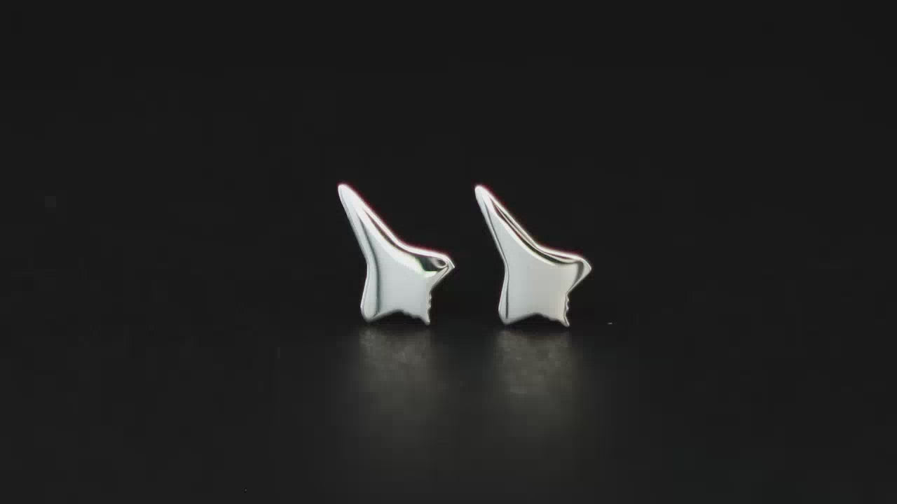 Load video: Pair of sterling silver NASA Space Shuttle Stud earrings on a turntable with a dark background