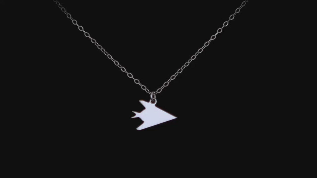 sterling silver F-117 silhouette necklace on a black background 