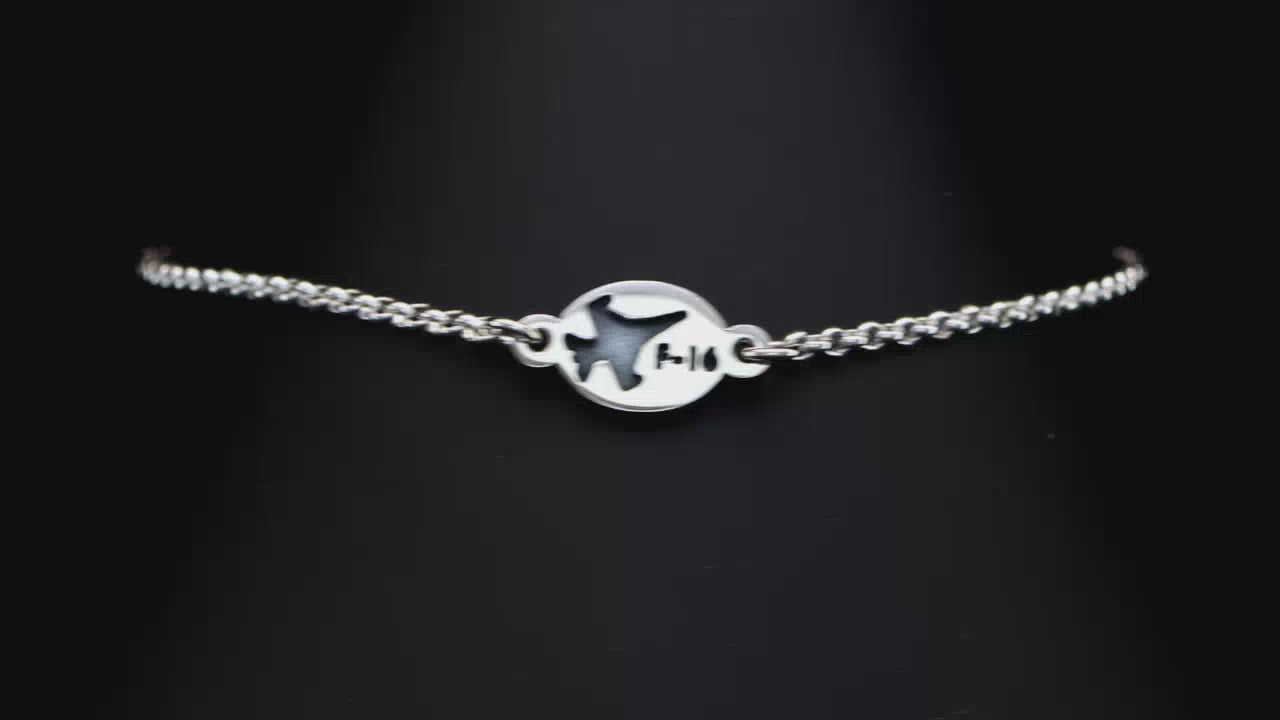 Load video: Close up video of an engraved B-2 Bomber Chain charm bracelet on a turntable