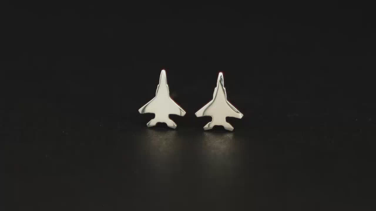 Pair of sterling silver F-15 Military Jet Fighter Stud earrings shown on a turntable with a dark background