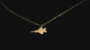 Gold F-35 Military Jet pendant necklace on a turntable with a dark background