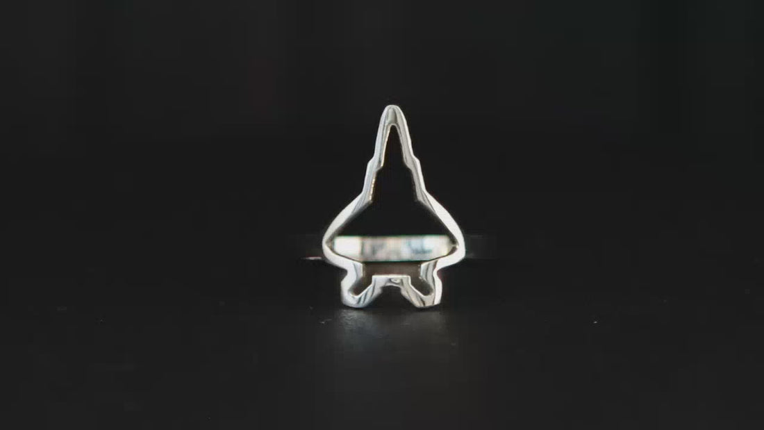 F-22 Fighter Jet outline sterling silver ring shown on a turntable with a dark background