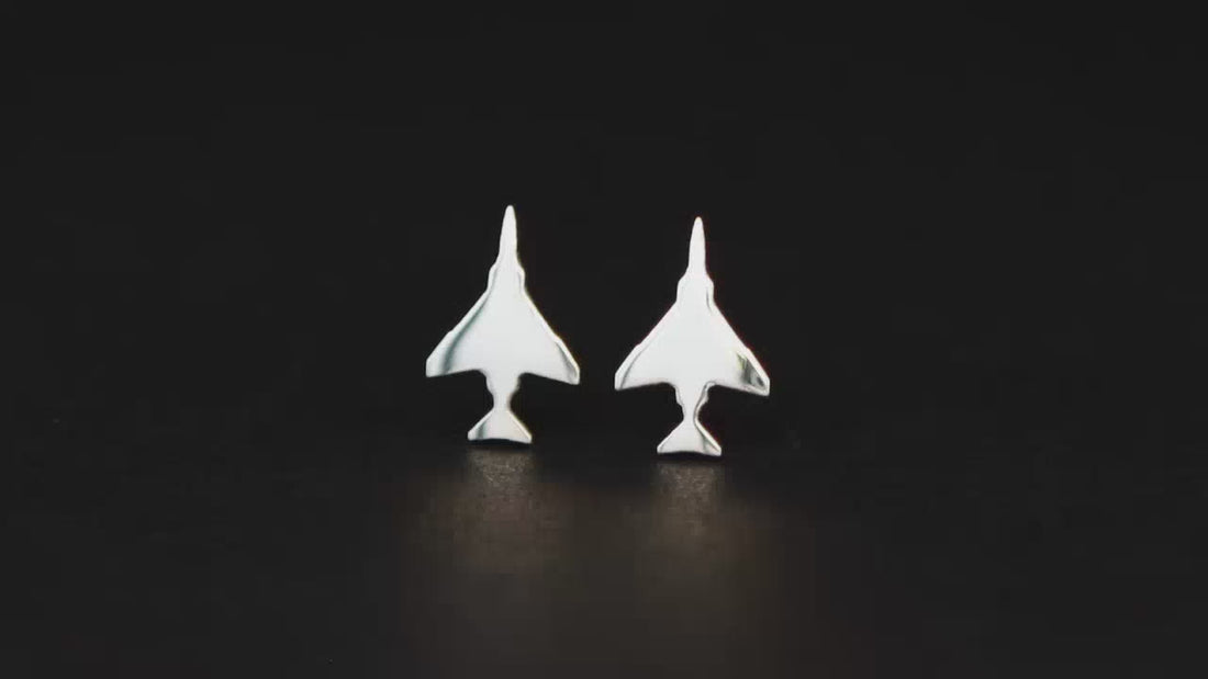 Silver F-4 Fighter Jet stud earrings shown on a turntable with a dark background