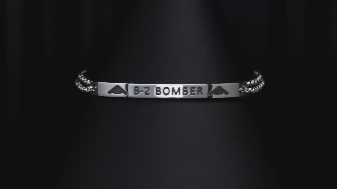 Load video: Close up video of an engraved B-2 Bomber Chain charm bracelet on a turntable