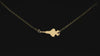 Gold F-35 Military Jet pendant necklace on a turntable with a dark background